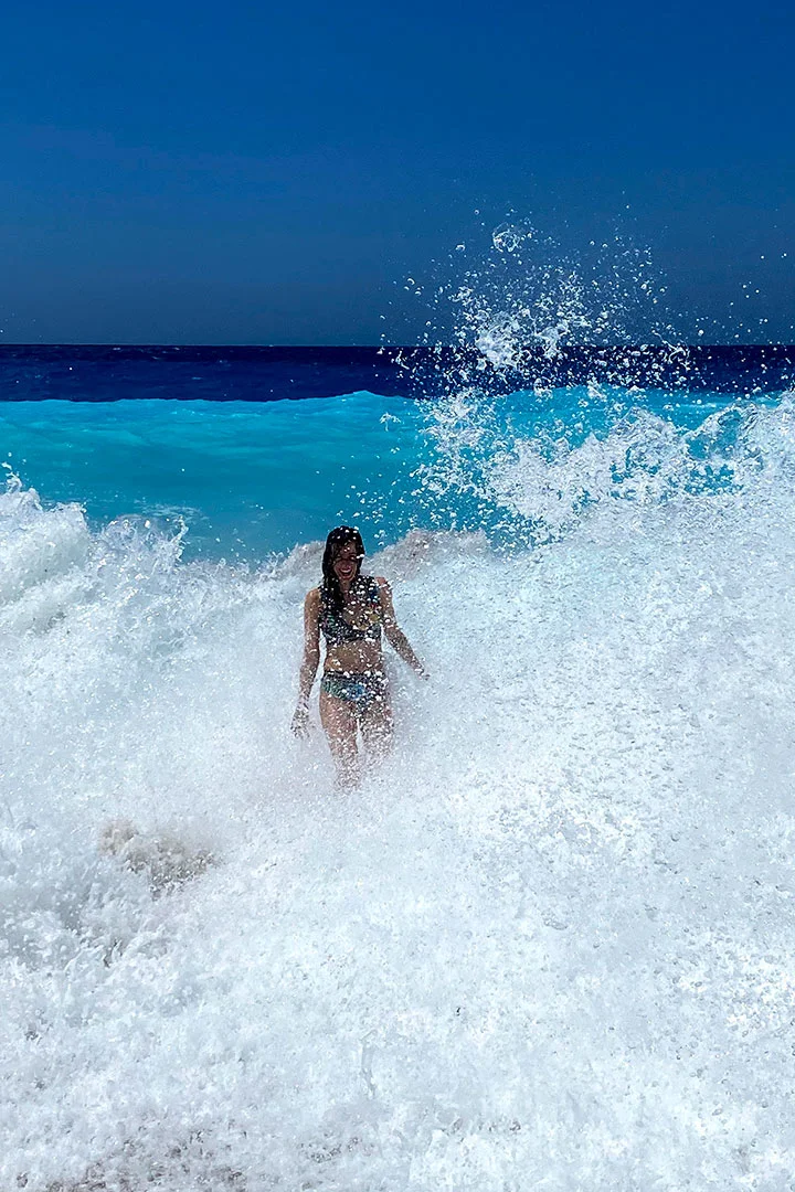 Woman in waves at Mylos beach in Lefkas Island