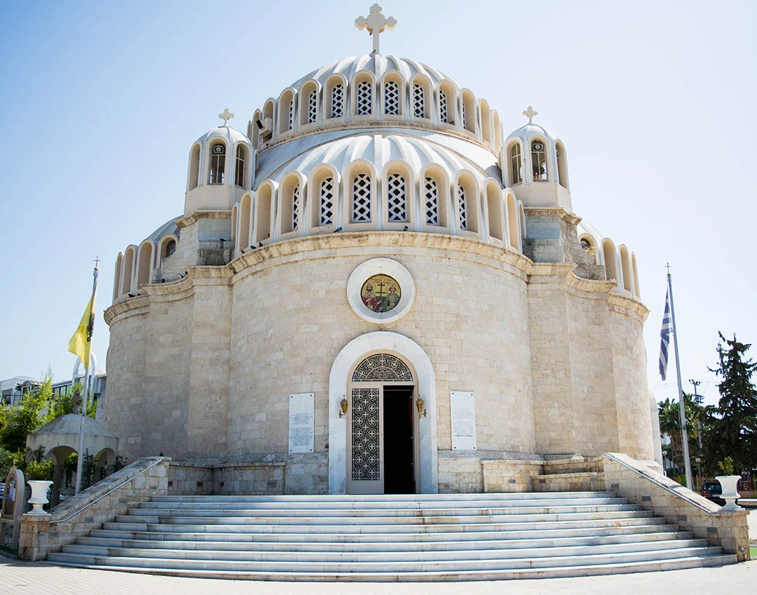 Big white Orthodox church building with stairs in Athens