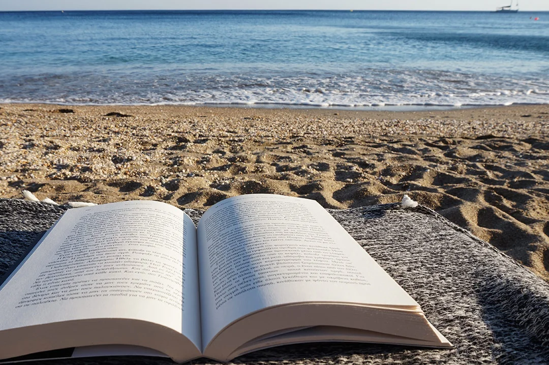 Book at the beach at Melos Island in Greece