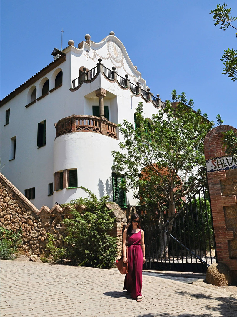 Woman in front of the White House in Park Güell, designed by Gaudi. Barcelona, Spain
