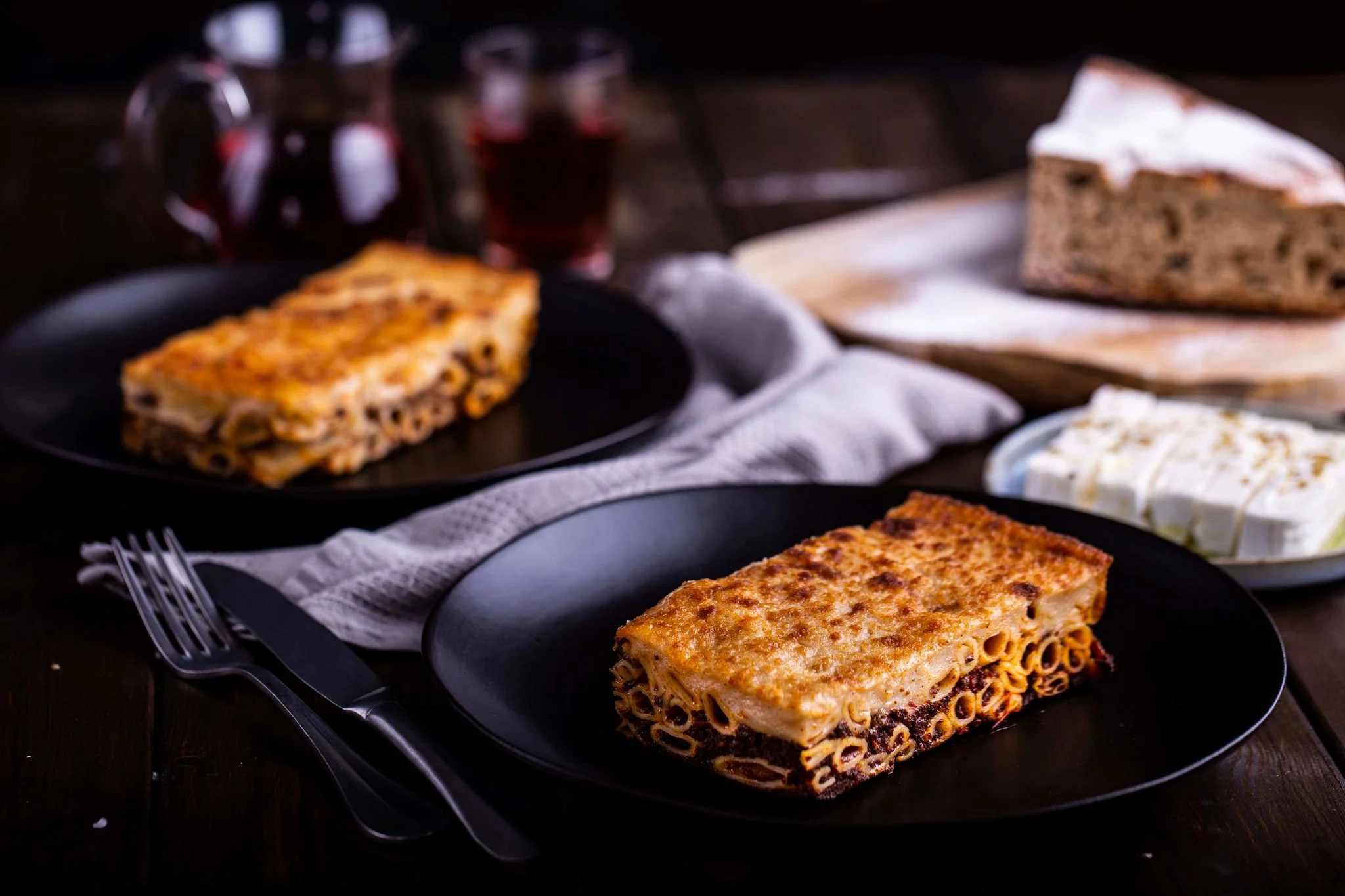 Traditional Greek Pastitsio piece on a black plate